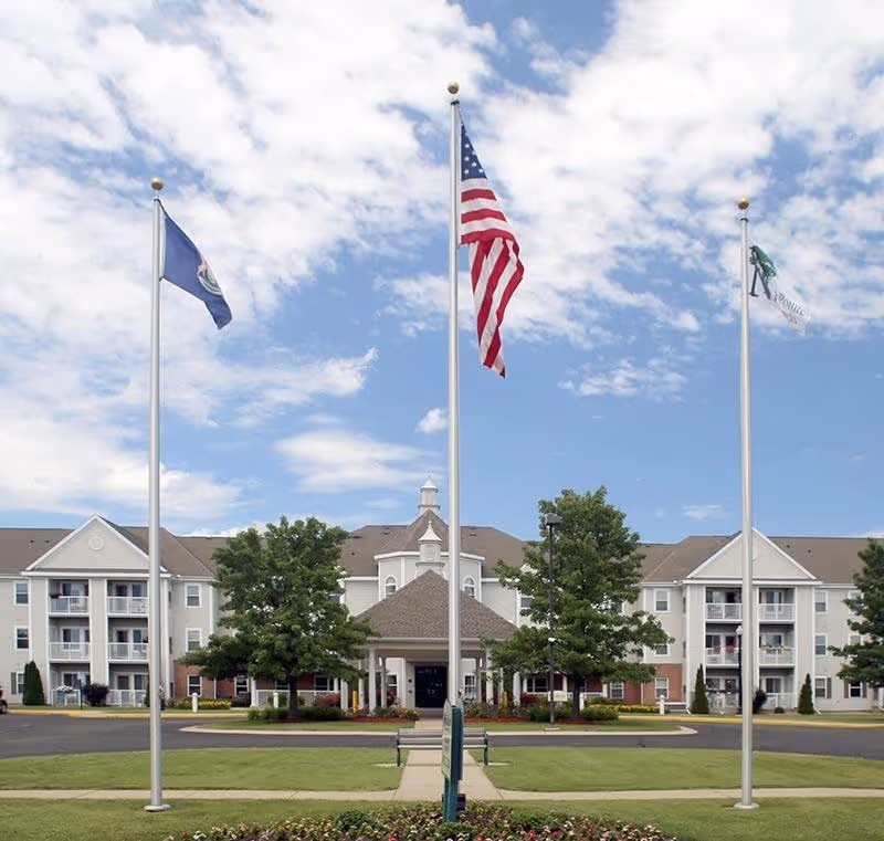 NorthPointe Woods facility exterior with flagpoles and manicured grounds