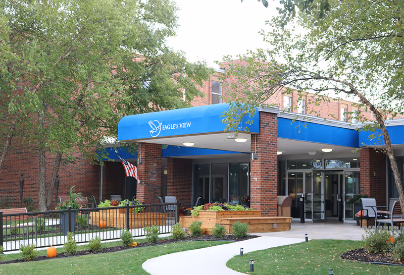 Exterior view of Eagle's View Supportive Living and Memory Care entrance with blue awning.