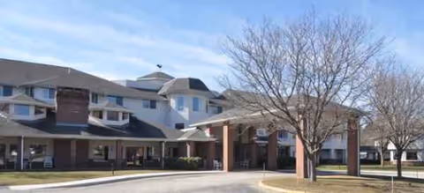 Exterior view of Anchor Bay at Pocasset senior living facility entrance.