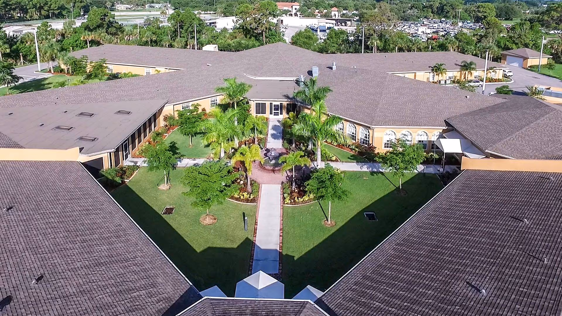 Aerial view of a landscaped central courtyard surrounded by single-story senior living buildings.