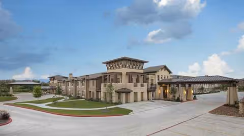 Exterior view of Landon Ridge Alamo Ranch Assisted Living & Memory Care building with driveway.