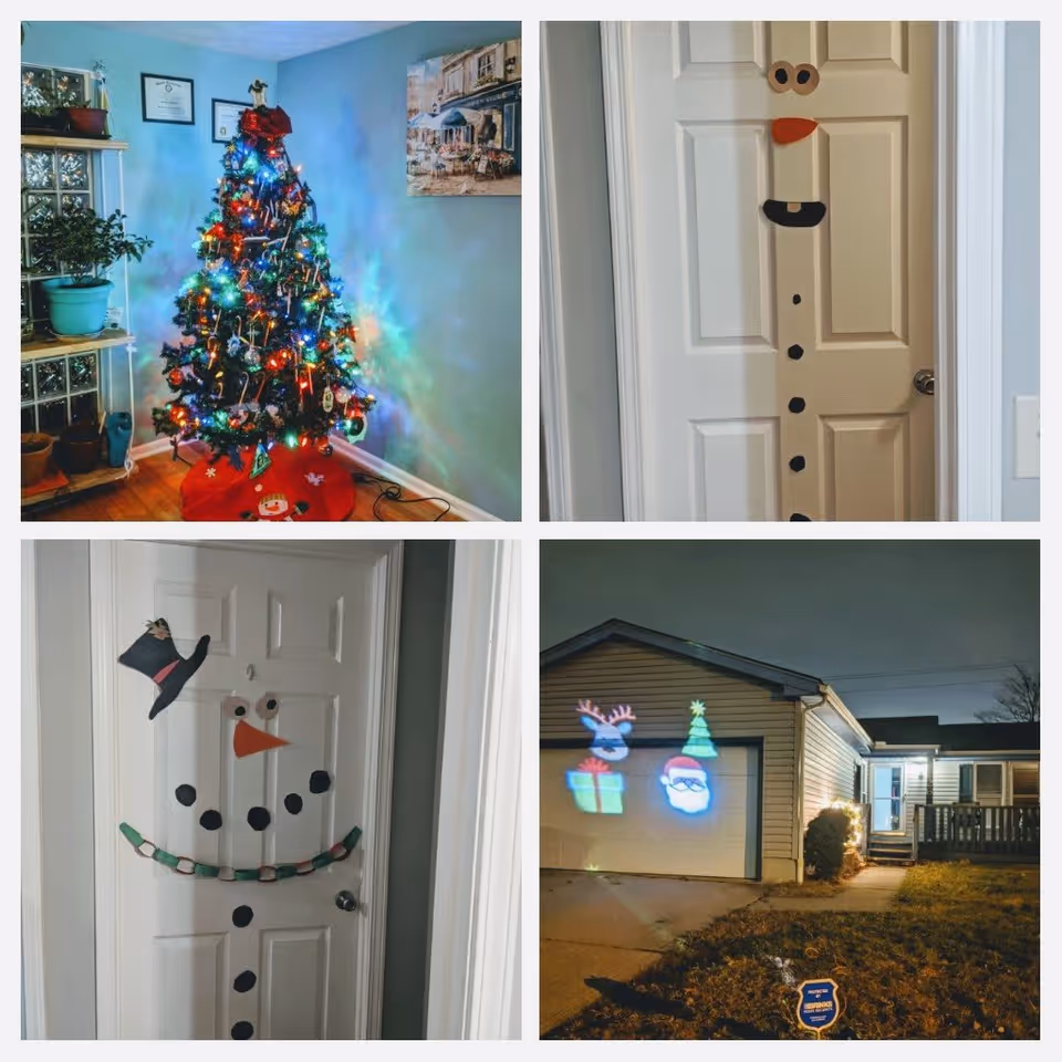 A collage of four images showing Christmas decorations at a senior care home. The top left image shows a decorated Christmas tree with colorful lights in a room with blue walls and some plants. The top right image shows a door decorated to look like a snowman with eyes, a carrot nose, and coal buttons. The bottom left image shows another door decorated as a snowman with a hat, eyes, carrot nose, coal mouth, and a paper chain scarf. The bottom right image shows the exterior of a house at night with Christmas light projections of a reindeer, Christmas tree, gift, and Santa Claus on the garage door.