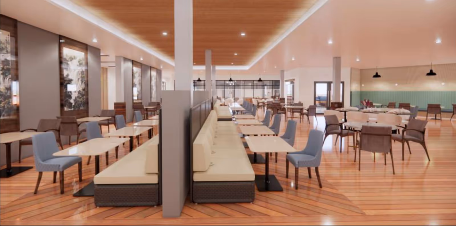 Spacious dining room with wooden floors and ceiling, featuring rows of tables with beige cushioned bench seating on one side and blue and brown chairs on the other. The room is well-lit with recessed lighting and pendant lamps, and has large windows and glass doors in the background.
