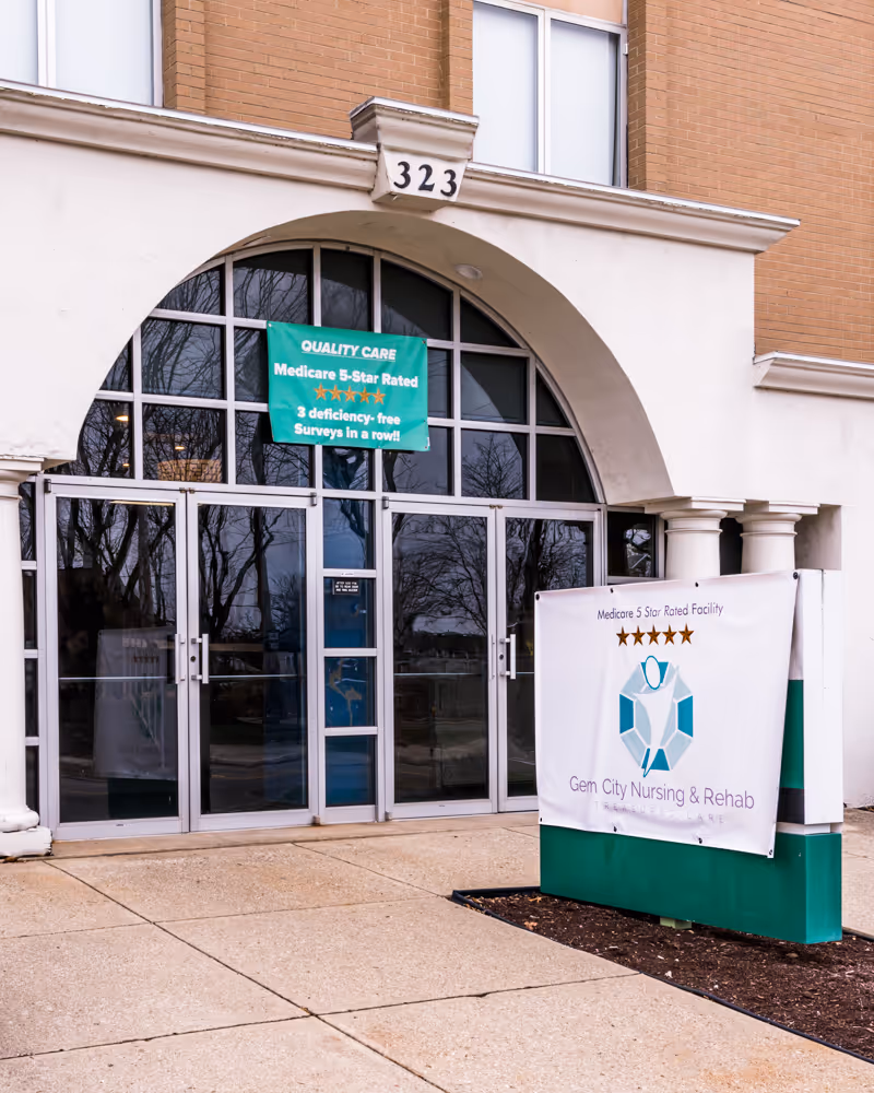 Entrance of Gem City Nursing and Rehabilitation Center with a banner highlighting its 5-star rating.