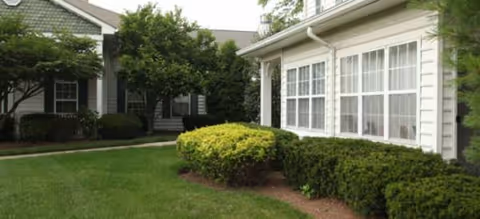 Exterior view of Brookdale Hillsborough with manicured lawn and shrubs.