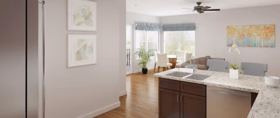 Bright and modern open kitchen and dining area with a marble countertop island featuring a sink and faucet, two gray chairs, wooden floor, large windows with blue valances, a round dining table with four chairs, a ceiling fan, potted plants, and abstract wall art.