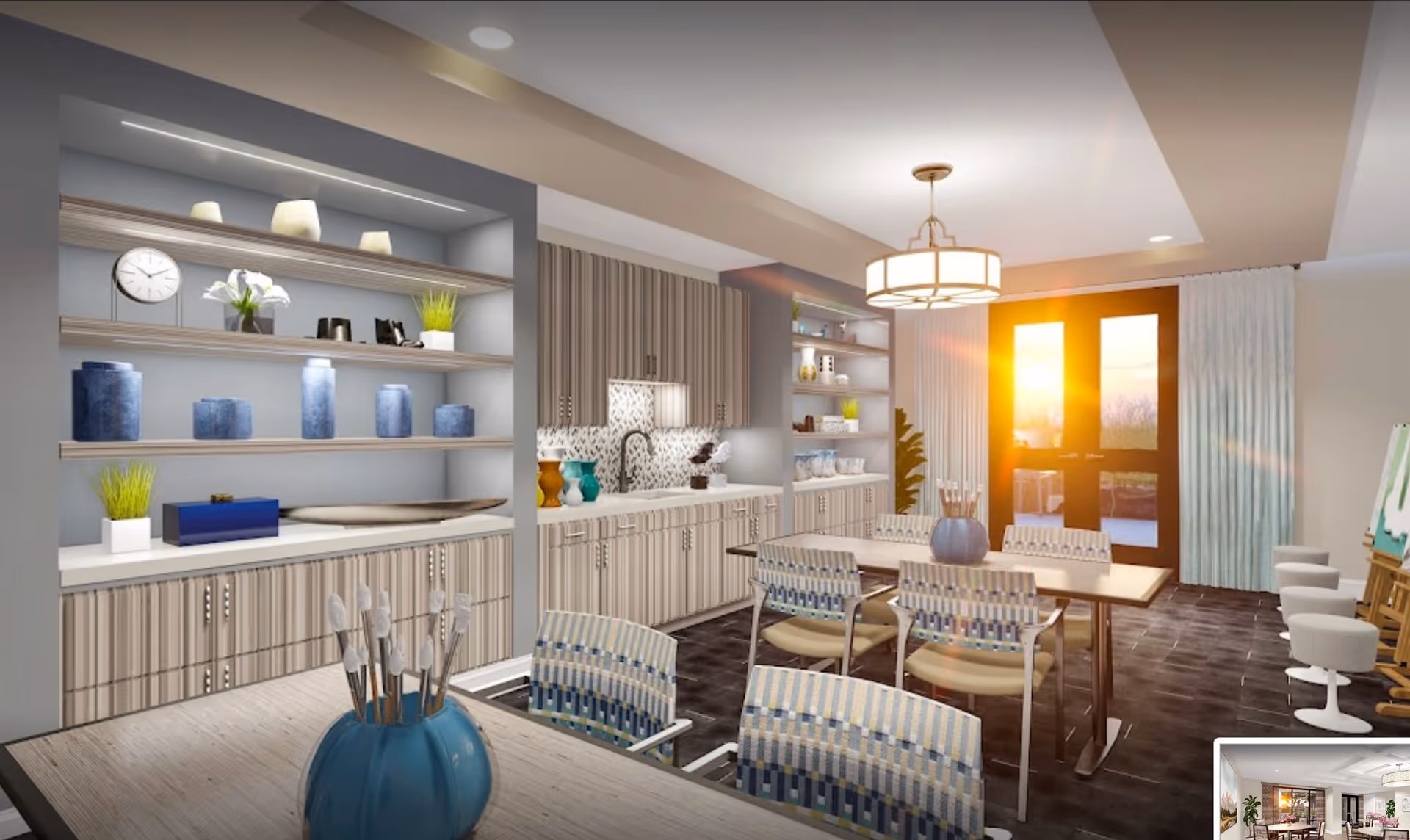 Sunlit dining and activity room with tables and patterned chairs, a kitchenette with open shelving and cabinets, and double doors letting in sunlight.