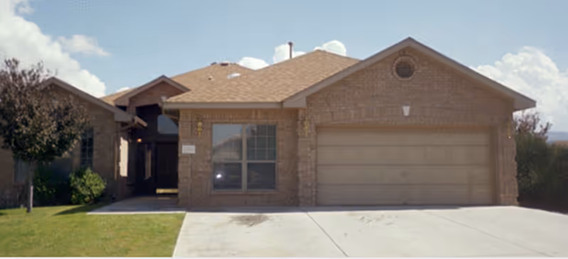 Brick-faced single-story building with a two-car garage in front, Willow Wood Assisted Living.