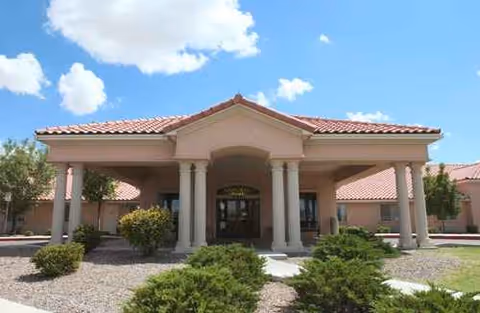 Front exterior of Regent Care Center, a single-story building with columns and a tiled roof.