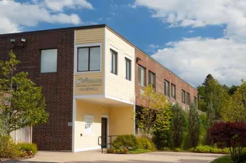Wingate at Haverhill exterior with brick facade, beige entry, and surrounding landscaping.