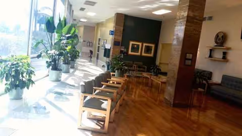 Bright Memorial Hospital of Gardena lobby with plants, sunlight, and row of waiting chairs.