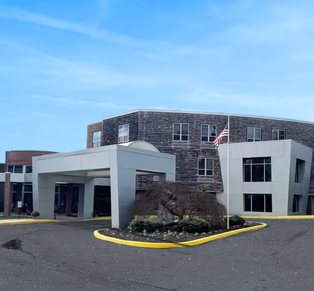 Exterior view of Springfield Crossings facility with entrance canopy and American flag