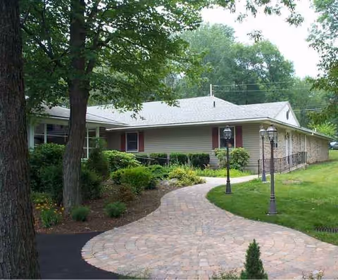 Single-story Walden III facility exterior with brick walkway and landscaped entrance.