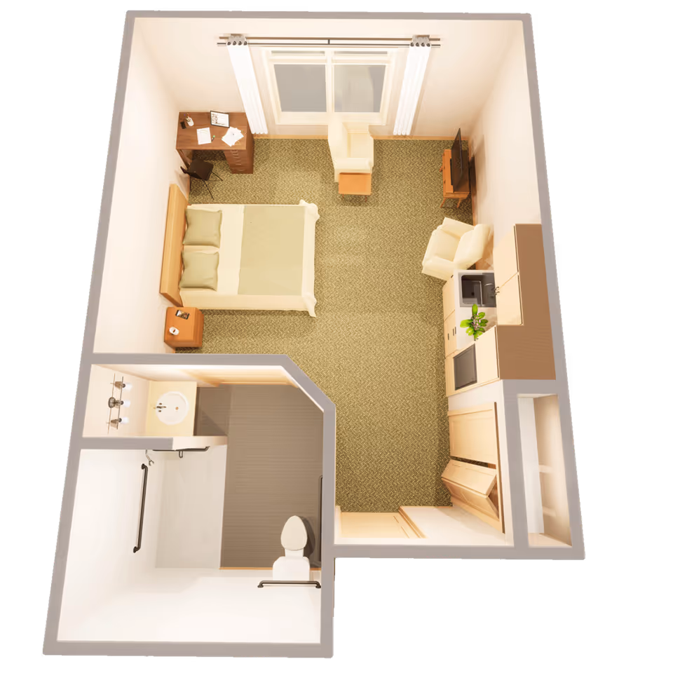 Top-down 3D floor plan of a studio assisted living apartment showing a bed, desk, seating area, kitchenette and bathroom.