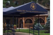 Canopy entrance reading 'Golden Hill Nursing & Rehabilitation Center' over a landscaped courtyard with wooden lattice pavilions.