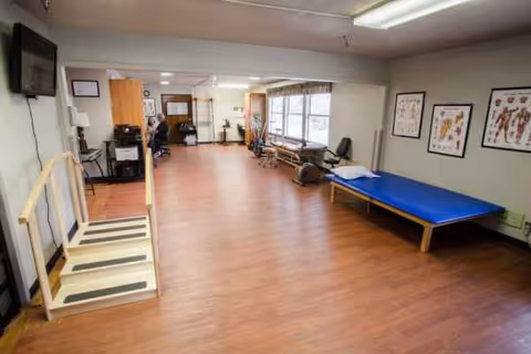 A spacious therapy room at Jefferson Health Care with exercise steps and a blue mat.