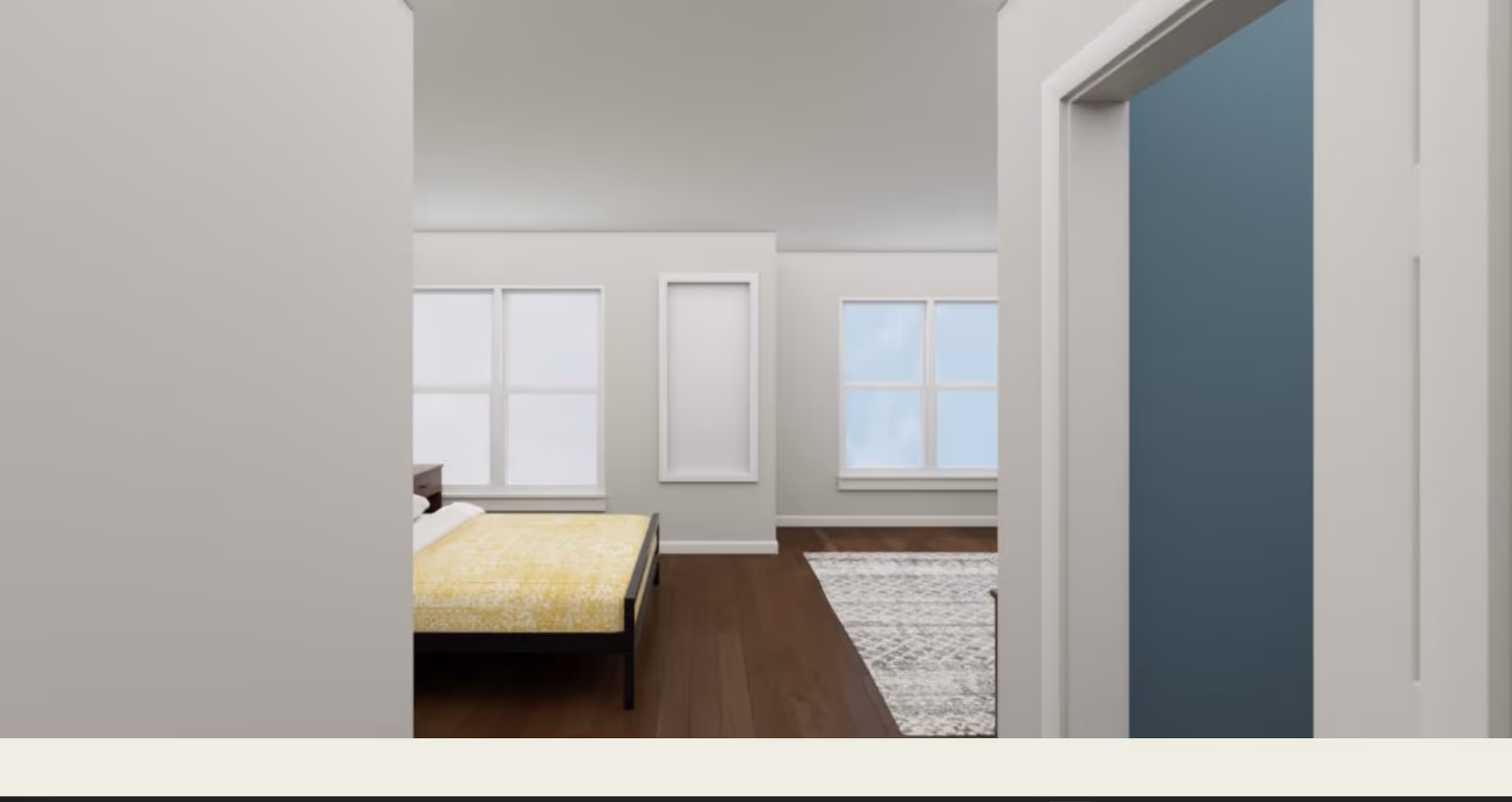 Interior view of a bedroom with a bed covered in a yellow blanket, two large windows letting in natural light, and a doorway leading to another room with a blue wall.