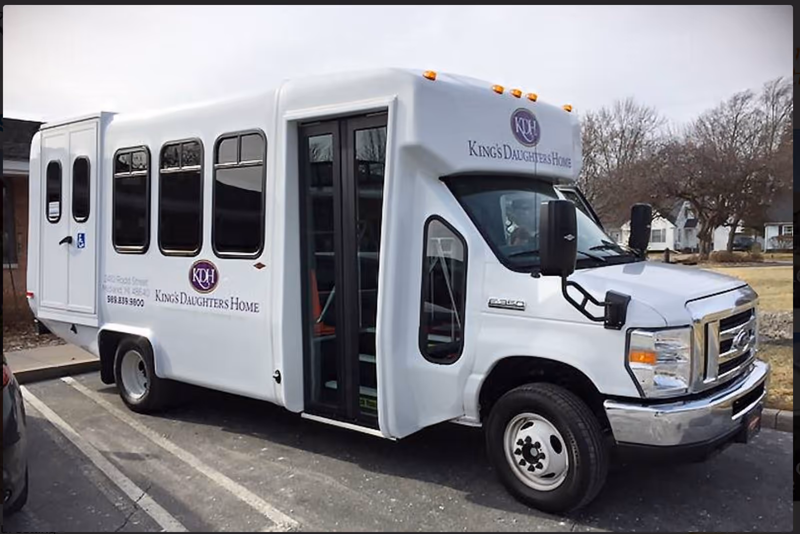 White shuttle bus labeled King's Daughters Home with open door.