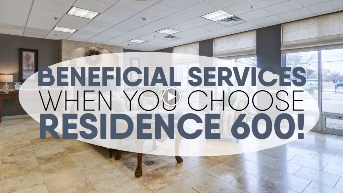 Lobby seating area with armchairs and large windows, partly covered by a promotional overlay reading "BENEFICIAL SERVICES WHEN YOU CHOOSE RESIDENCE 600!"