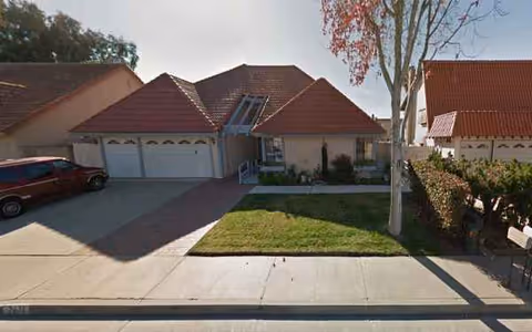 Exterior view of Candlewood House 1: a single-story building with attached garages and lawn.
