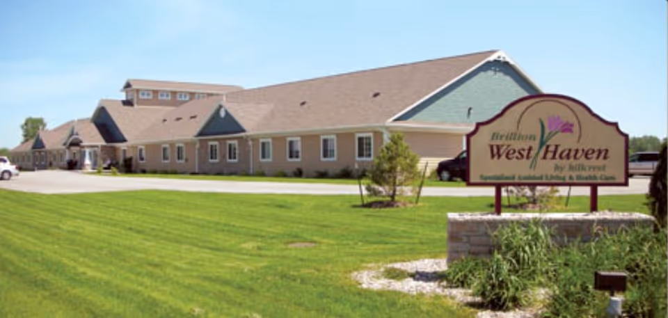Single-story senior living facility building with a manicured lawn and a 'Brillion West Haven' entrance sign.