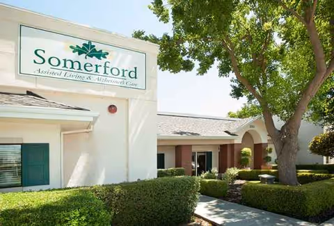 Exterior view of Summerfield of Stockton senior living facility with sign and landscaping.