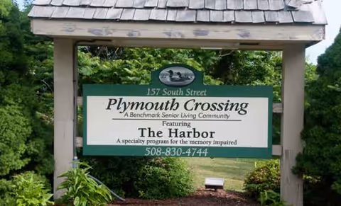 Outdoor entrance sign for Plymouth Crossing Senior Living, featuring The Harbor program.