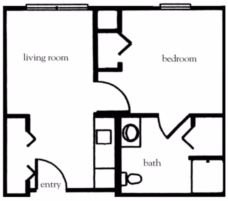 Black and white architectural floor plan showing a layout with labeled rooms including living room, bedroom, bath, and entry. The plan includes walls, doors, and fixtures such as a toilet and sink in the bath area.