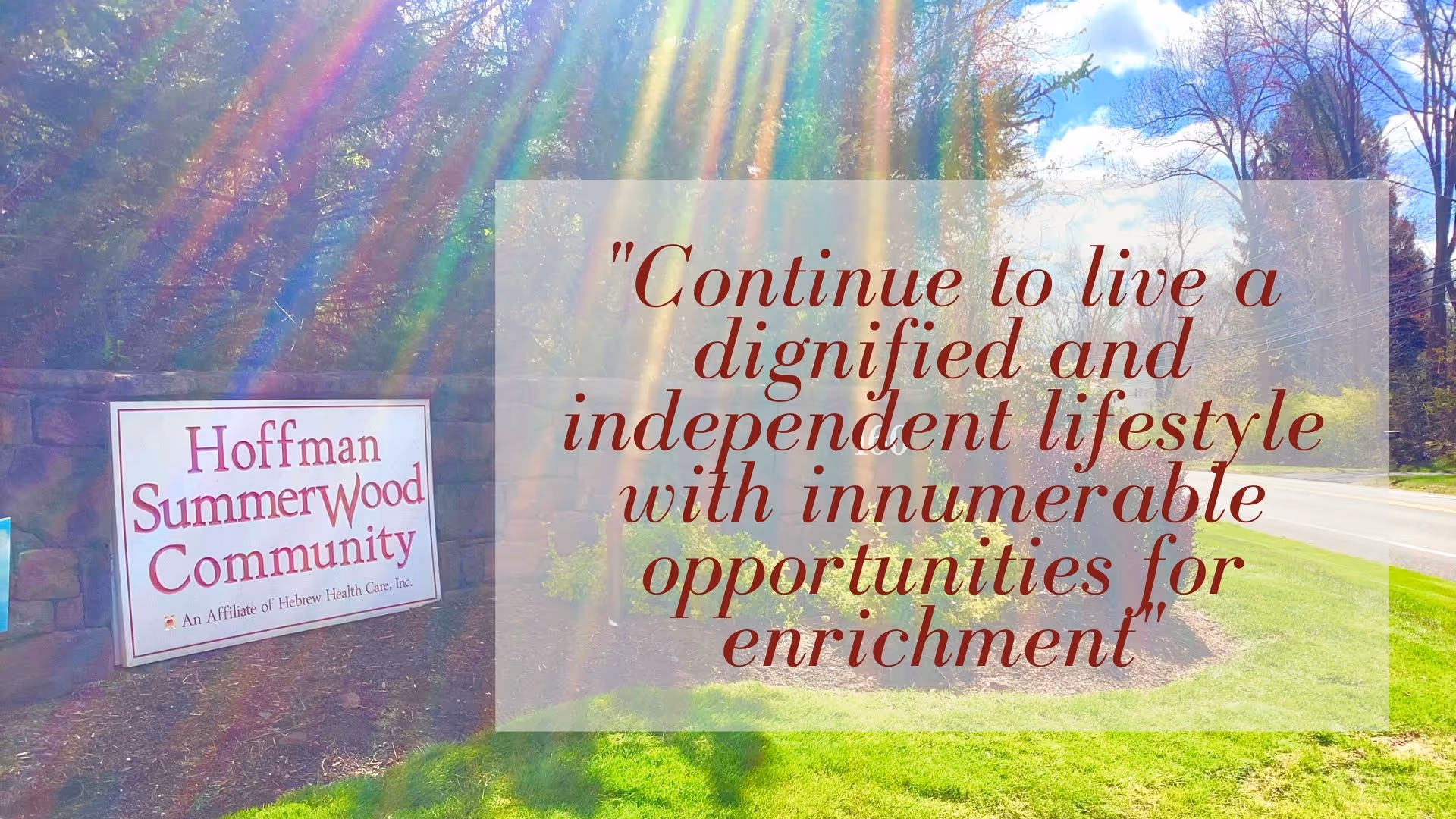 Entrance sign reading 'Hoffman SummerWood Community' by a roadway with a large overlaid inspirational quote.