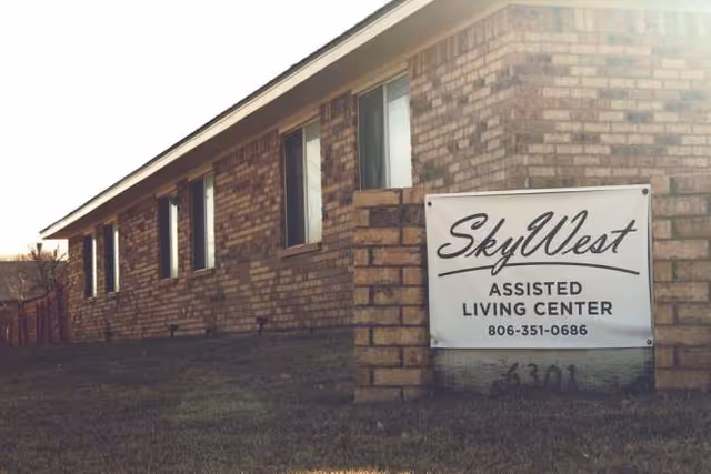Exterior view of SkyWest Assisted Living Center sign on brick building