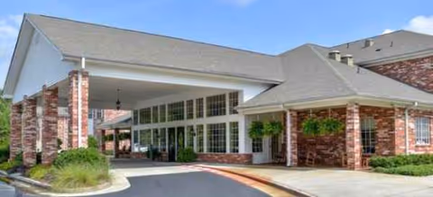 Front view of Brookdale Rome's brick entrance with a covered drop-off area.