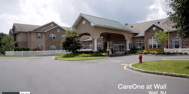 Exterior view of CareOne at Wall senior living entrance with a circular driveway.