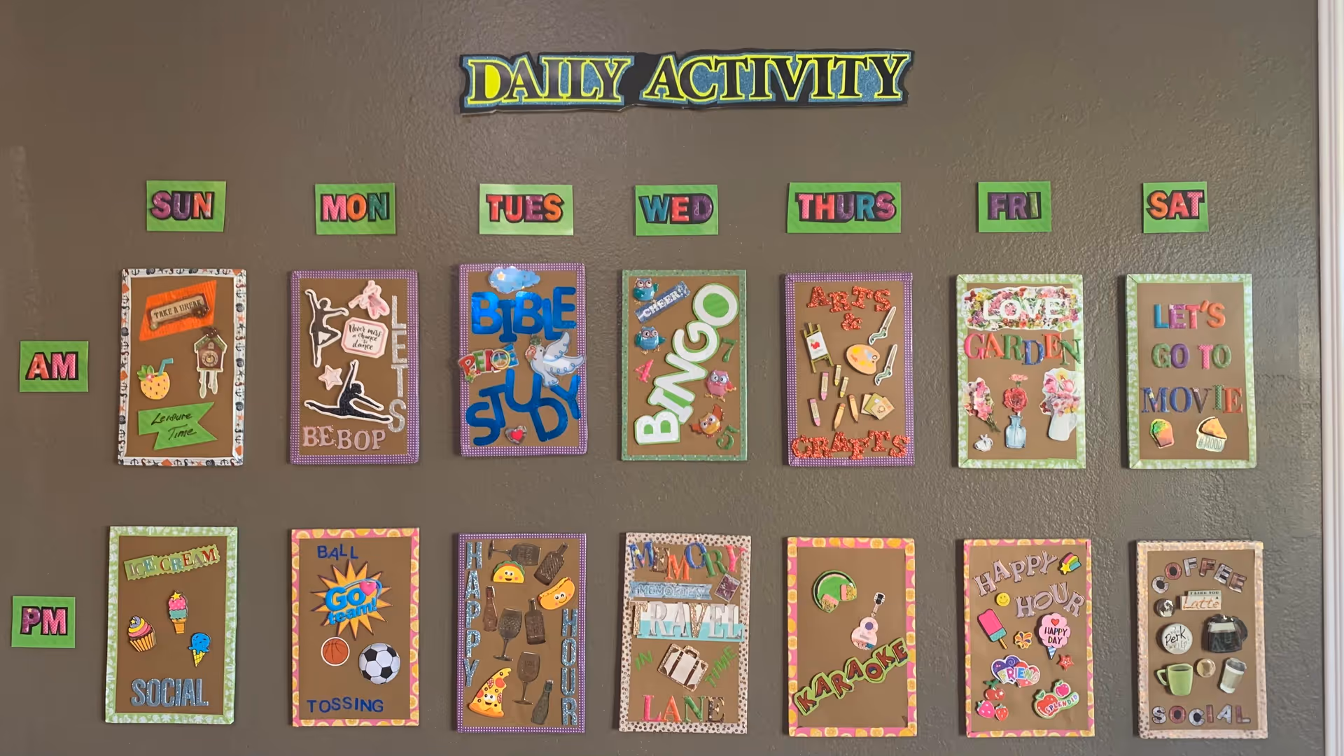 A bulletin board displaying a weekly schedule of daily activities with colorful paper cutouts and decorations. The board is titled 'Daily Activity' and is divided by days of the week from Sunday to Saturday, with separate sections for AM and PM activities. Activities include leisure time, dance, Bible study, bingo, arts and crafts, gardening, movies, social events, ball tossing, happy hour, karaoke, and coffee social.