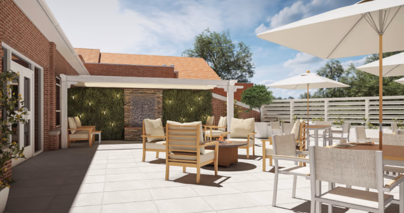 Sunny outdoor patio with seating, umbrellas, a pergola, and a green wall fountain.