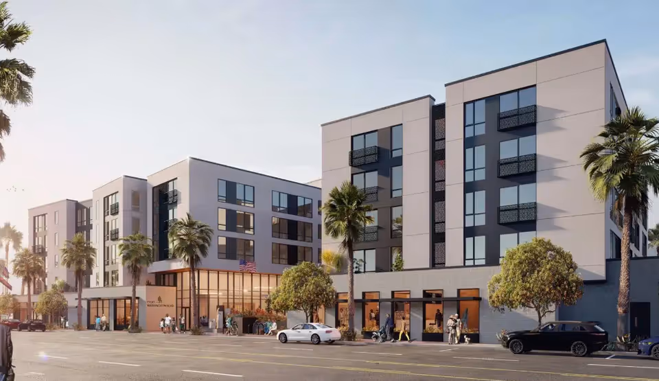 Modern multi-story senior living building front with palm trees and cars.