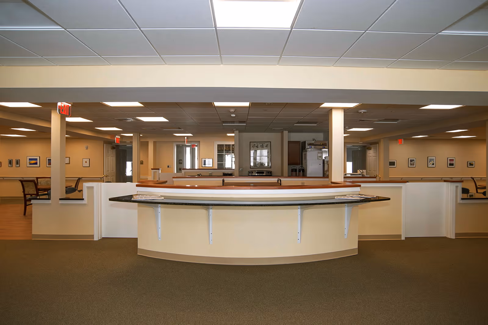 Spacious interior reception/nurses' station with a curved counter and seating areas in the background.