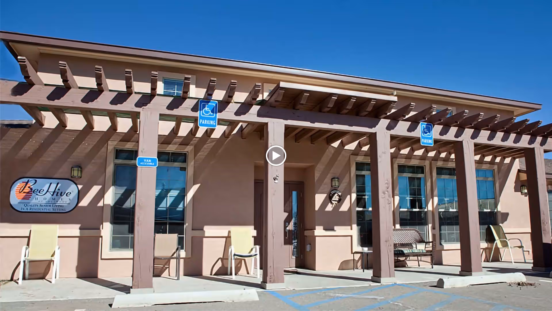 The exterior of BeeHive Homes Assisted Living featuring a covered entrance and signage.