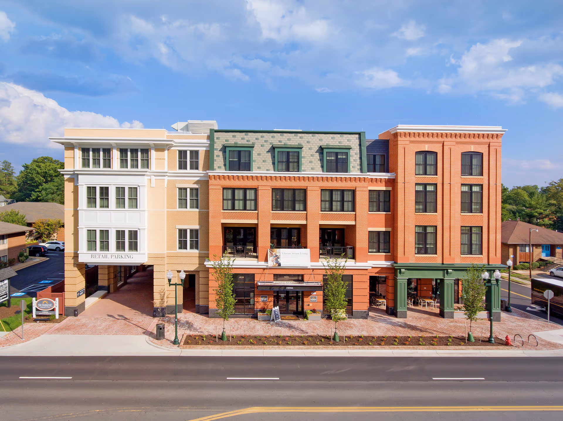 Sunrise of Vienna building exterior along a street with brick facade and shops.