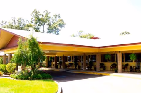 Exterior view of Mccomb Nursing and Rehabilitation Center with a covered entrance
