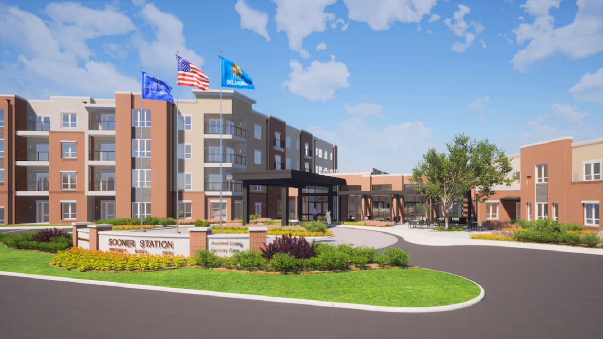 Exterior view of a multi-story senior living facility with entrance canopy and flags.