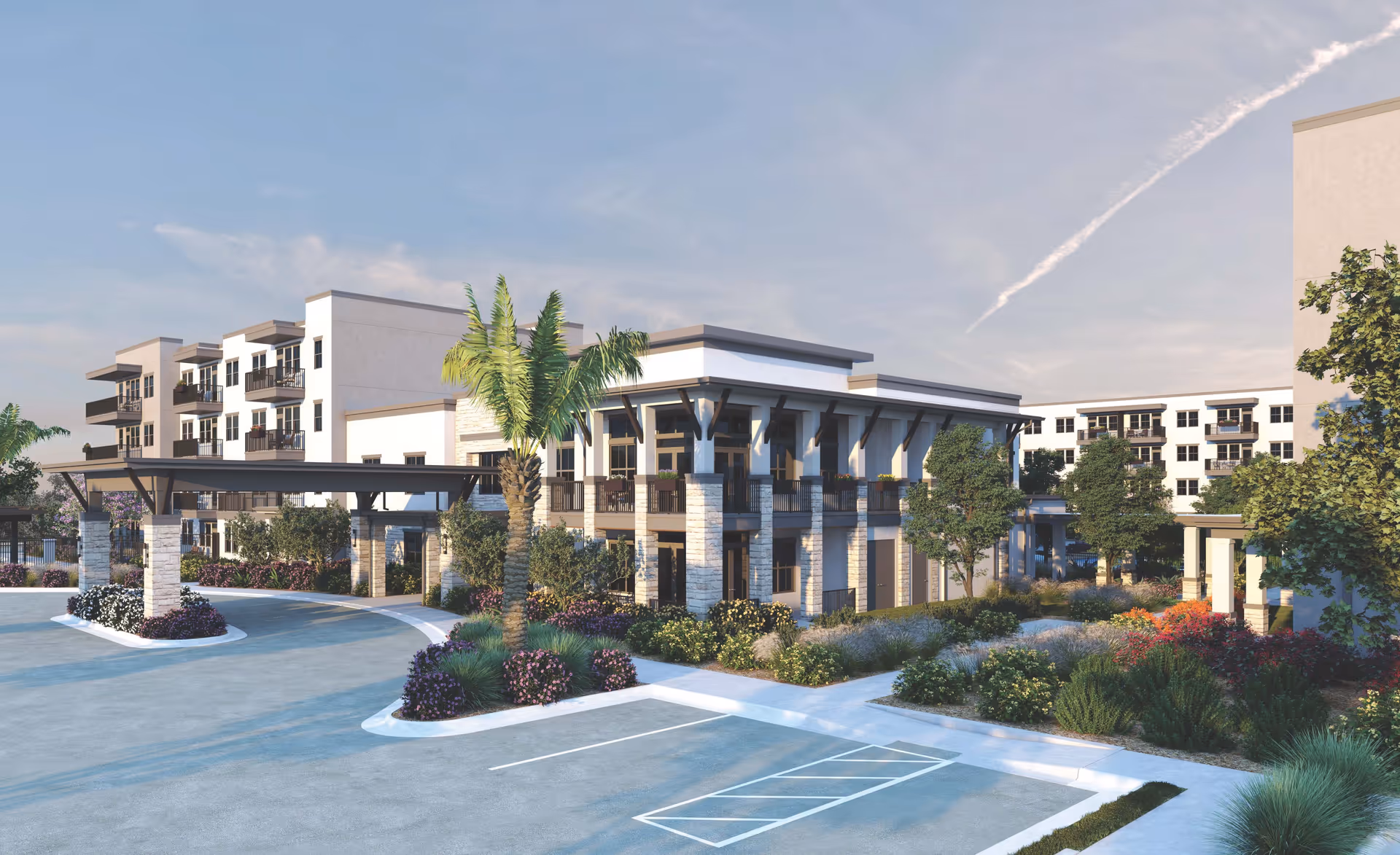 Exterior view of a modern senior living facility named Mera Westgate, featuring a multi-story building with balconies, a covered entrance, landscaped gardens with palm trees and shrubs, and a parking area in the foreground under a partly cloudy sky.