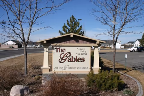 Outdoor sign for The Gables Assisted Living at the facility entrance with landscaping.
