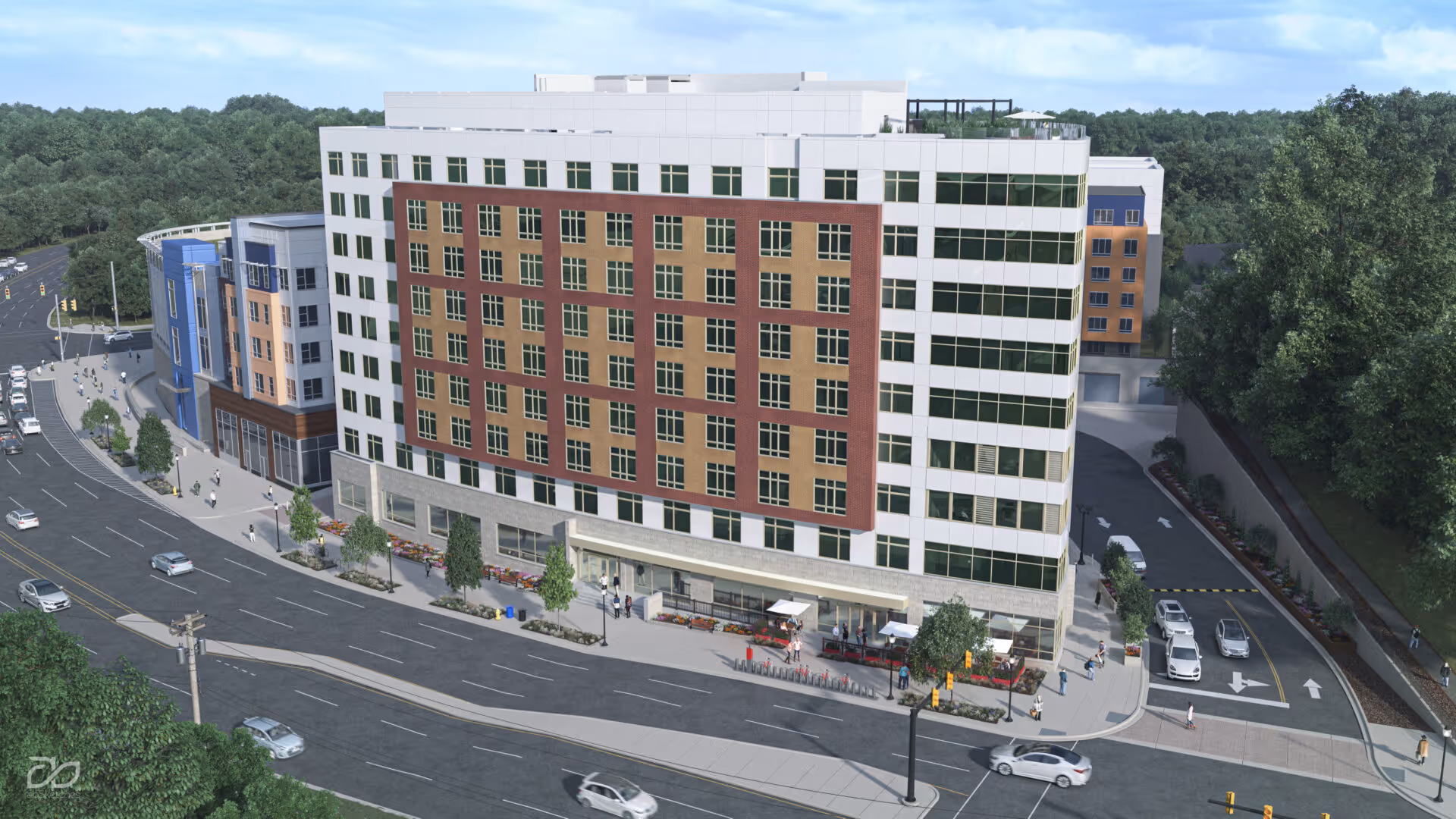 A multi-story modern building with a mix of white, brown, and blue exterior walls, large windows, and a rooftop garden. The building is situated along a busy street with cars and pedestrians. Trees and greenery surround the area.