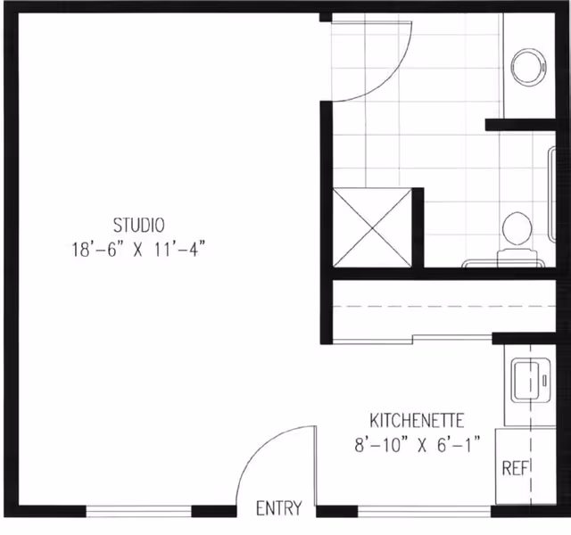 Floor plan of a studio apartment at Fellowship Square Tucson showing an entry leading into a kitchenette area with a refrigerator and sink, a studio living space measuring 18 feet 6 inches by 11 feet 4 inches, and a bathroom with a shower, toilet, and sink.