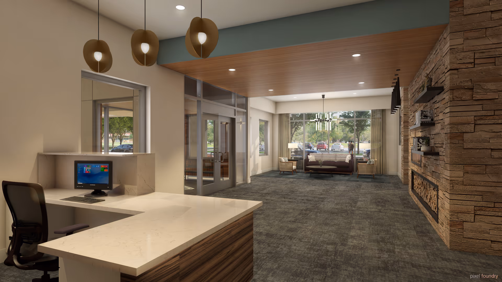 Interior view of a senior living facility lobby with a reception desk on the left, a computer on the desk, modern pendant lights hanging from the ceiling, a seating area with chairs and a sofa near large windows showing a parking lot and trees outside, and a stone wall with built-in shelves and a fireplace on the right.