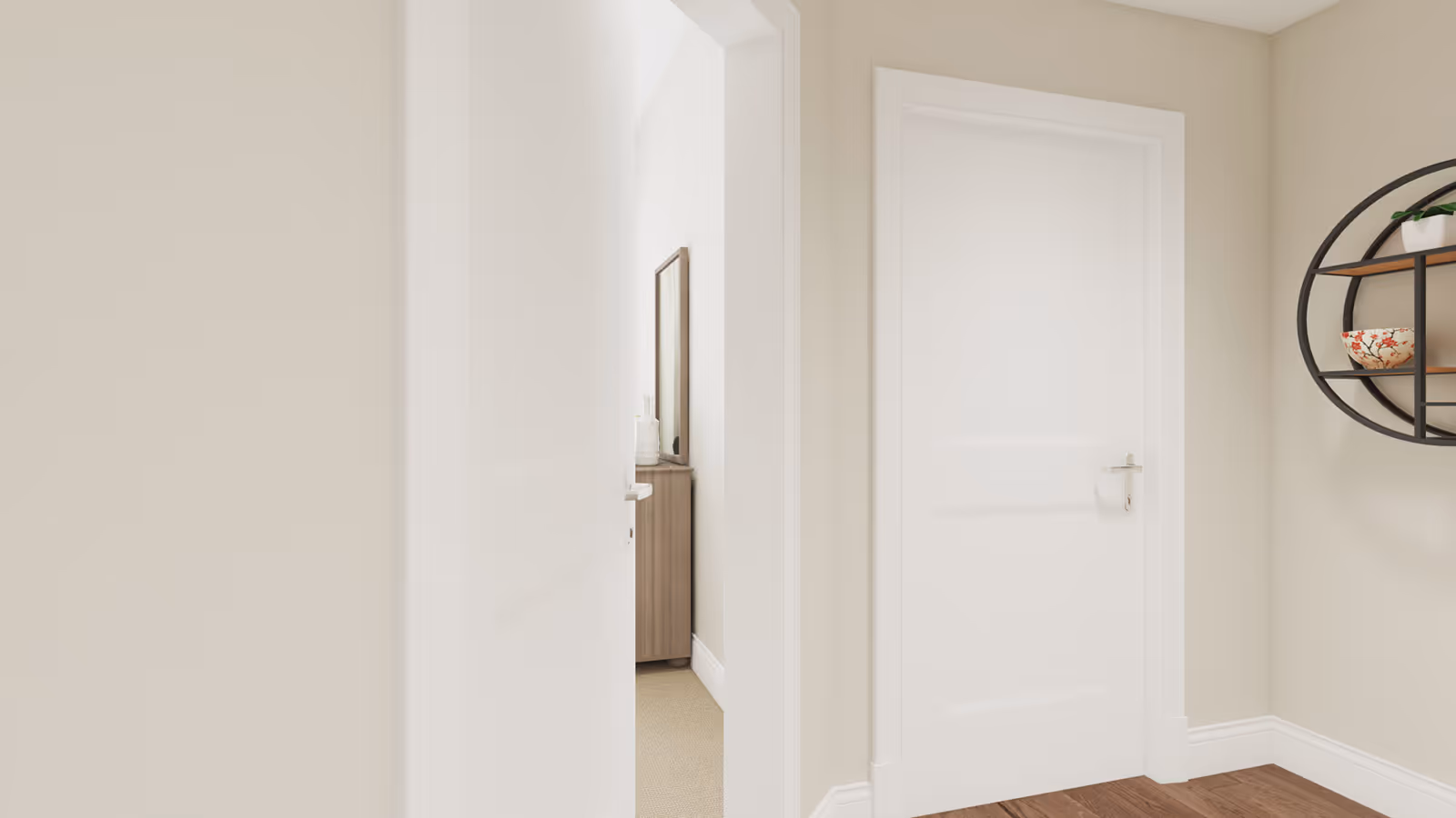 A hallway with two white doors, one slightly open revealing a wooden dresser with a mirror and decorative items inside the room. The walls are painted beige, the floor is wooden, and there is a round black metal wall shelf with decorative bowls and a small plant on the right wall.