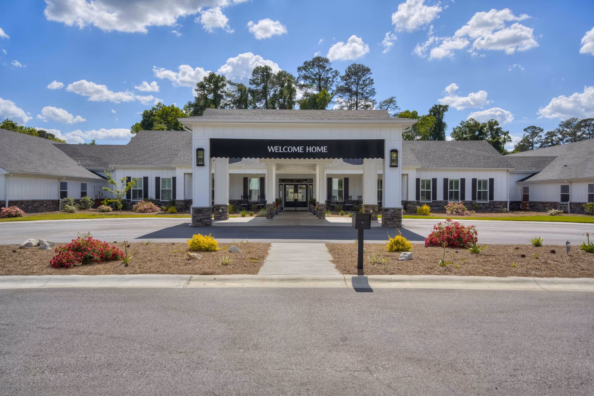 Front exterior of a single-story senior living facility with a welcoming entrance and landscaped grounds.