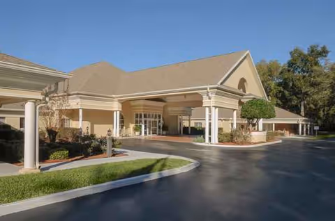 Exterior view of Life Care Center of Citrus County featuring a covered entrance and driveway