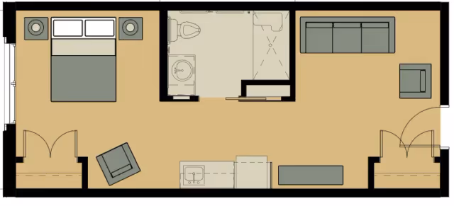 Floor plan of a living space featuring a bedroom with a double bed and two nightstands on the left, a bathroom with a toilet, sink, and shower in the center top, and a living room area with a sofa, armchair, and a small table on the right. The kitchen area is along the bottom wall with a sink and counter space.