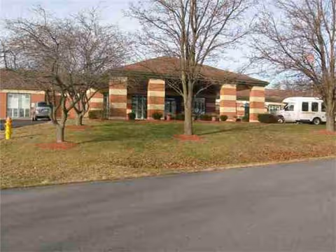 Exterior front view of Grandview Healthcare Center, a brick building with an entrance and trees nearby.